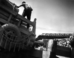 Two Men Unloading Pulpwood Truck