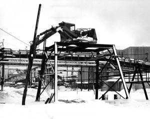 Machine Used to  Break Down Frozen Wood Chips in Freight Cars