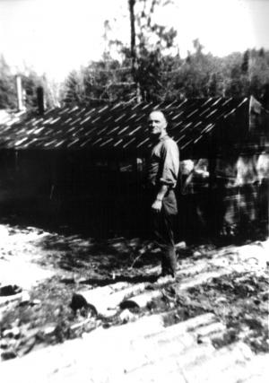 Mr. Chum Landry in Front of a  Lumber Camp