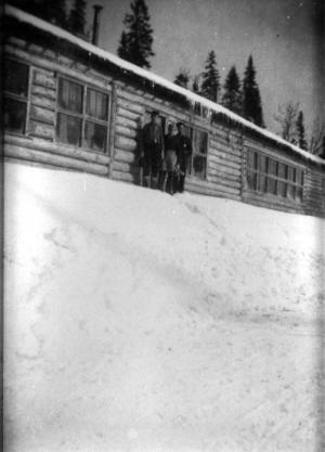 Workers in Front of a Log Cabin