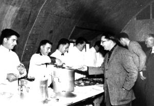 Cooks Serving Meals to  Visitors