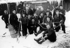 A Group of  Loggers Near a Camp