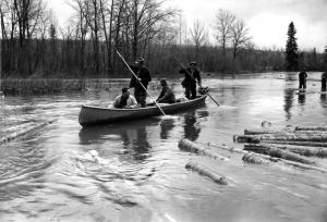 Drivers on a Boat Sweep the River with Pike Poles