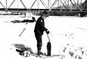 Mr. Ral Levasseur is Cutting a  Hole in  Ice with a Saw