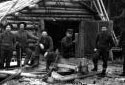 Workers in Front of a Log Camp