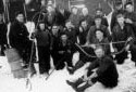 A Group of  Loggers Near a Camp