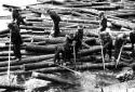 Drivers Releasing Logs at a Bridge Abutment