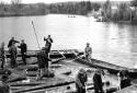 Drivers Releasing Logs at Bridge Abutment