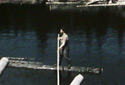 Man Balancing on a Log Goes Downstream