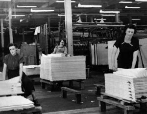 Three Workers Inspecting Paper